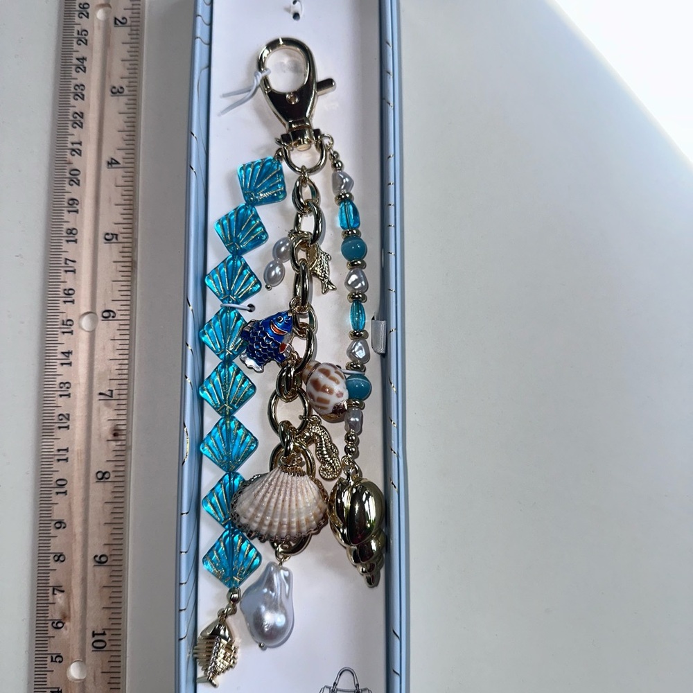 Viral glass Gold and Blue Key and Bag charm.